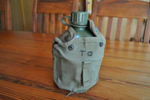 Old Army Water Bottle And Fire Bucket