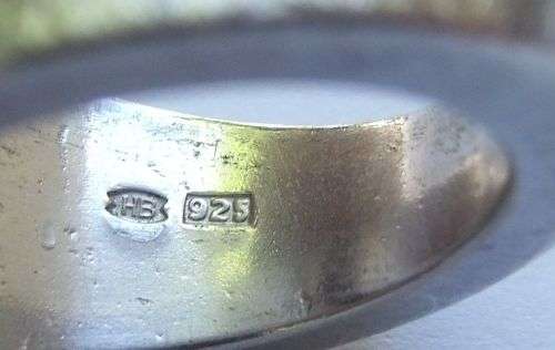 A thick heavy quality designer stamped sterling silver ring set with a faceted Sapphire