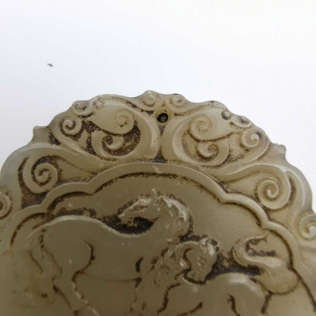 The Hetian Jade of the Qing Dynasty in China is a jade pendant with both Carving(ZI-GANG)