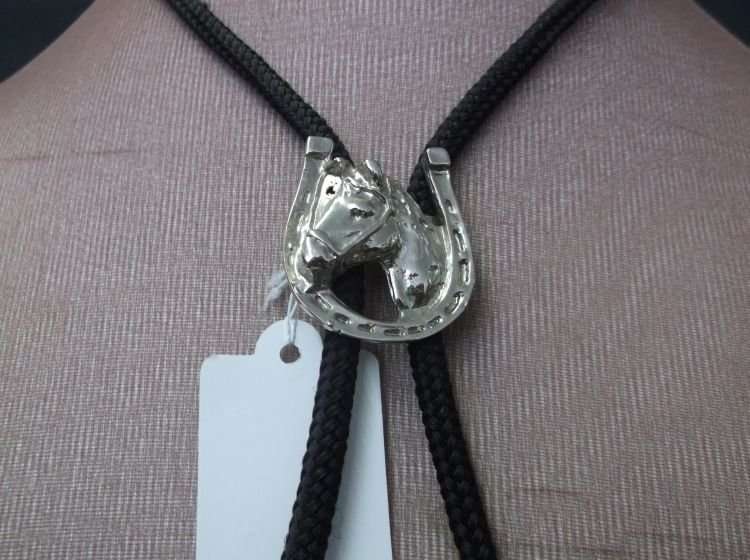 A LUCKY VINTAGE BOLO TIE WITH HORSE AND HORSESHOE MOTIF....COWBOY ACCESSORY !!