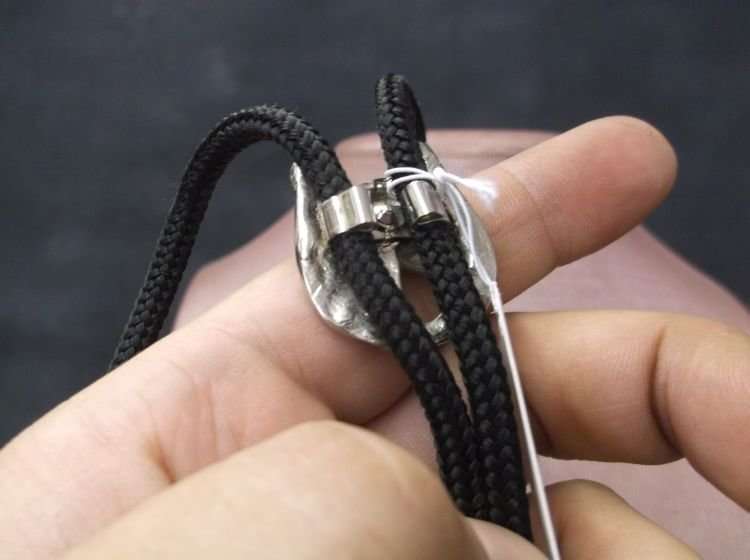 A LUCKY VINTAGE BOLO TIE WITH HORSE AND HORSESHOE MOTIF....COWBOY ACCESSORY !!