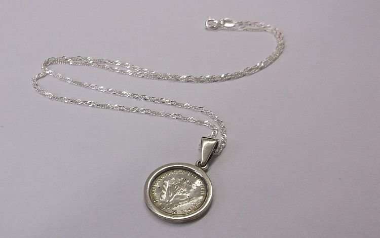 A LOVELY NEW STERLING SILVER NECKLACE WITH AN OLD STERLING SILVER PENDANT SET WITH A SILVER TICKEY !