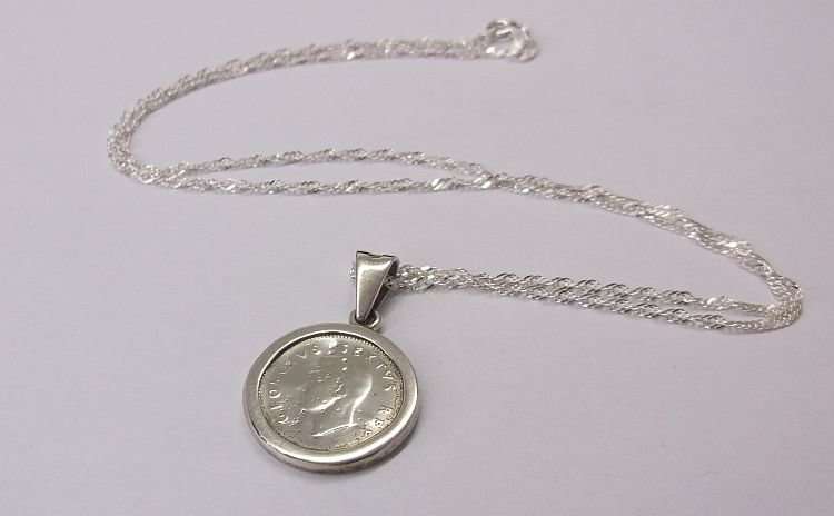 A LOVELY NEW STERLING SILVER NECKLACE WITH AN OLD STERLING SILVER PENDANT SET WITH A SILVER TICKEY !