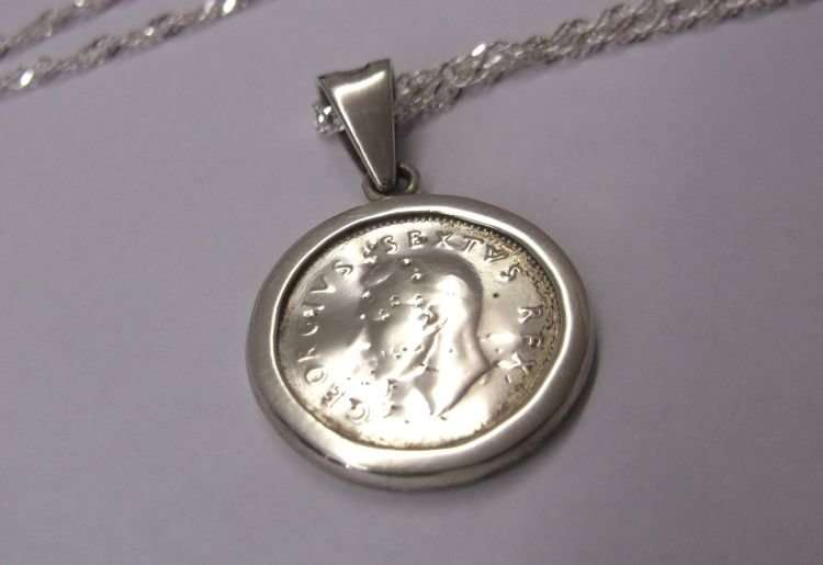 A LOVELY NEW STERLING SILVER NECKLACE WITH AN OLD STERLING SILVER PENDANT SET WITH A SILVER TICKEY !