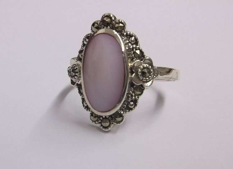AN OUTSTANDING AND FANCY SOLID STERLING SILVER RING WITH MARCASITE AND A PINK INSET