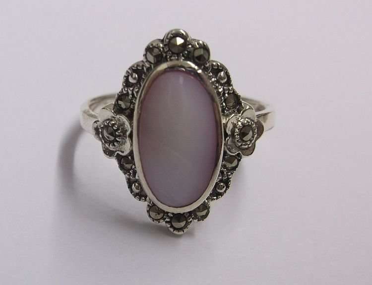 AN OUTSTANDING AND FANCY SOLID STERLING SILVER RING WITH MARCASITE AND A PINK INSET