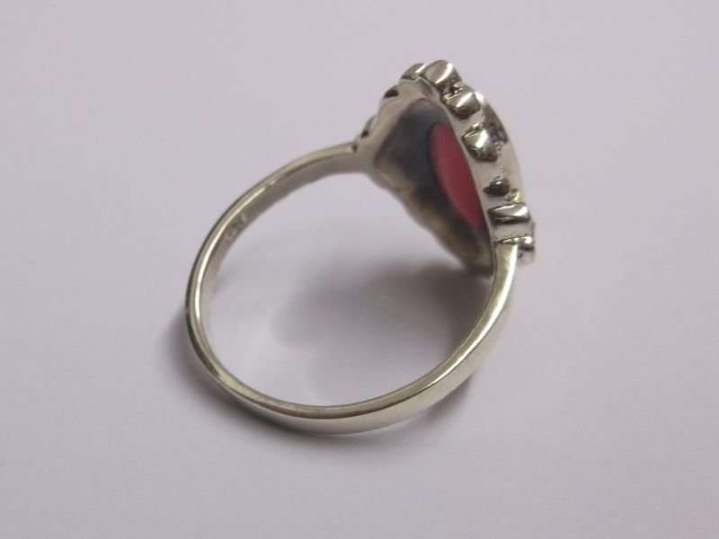 AN OUTSTANDING AND FANCY SOLID STERLING SILVER RING WITH MARCASITE AND A PINK INSET