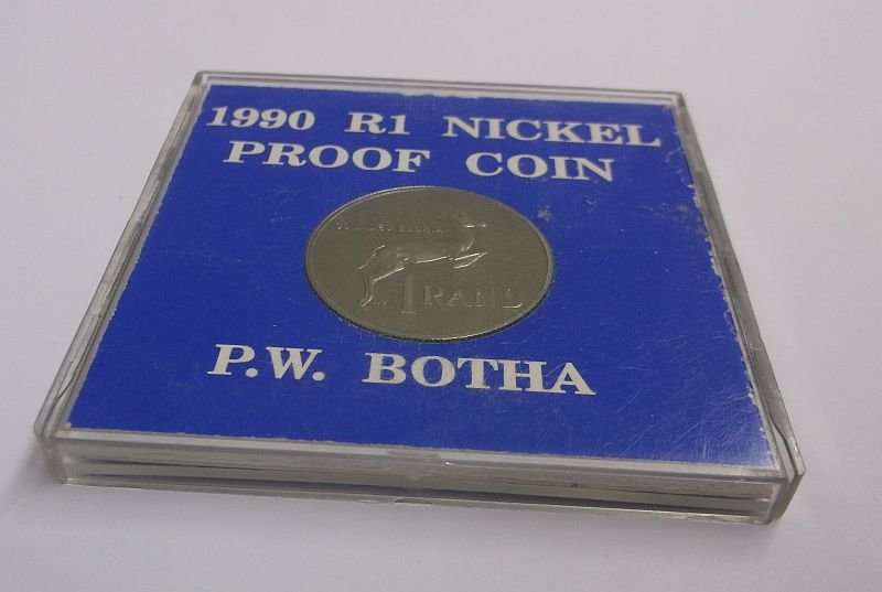 A PROOF 1990 ONE RAND COIN IN ITS PLASTIC HOLDER - P.W BOTHA
