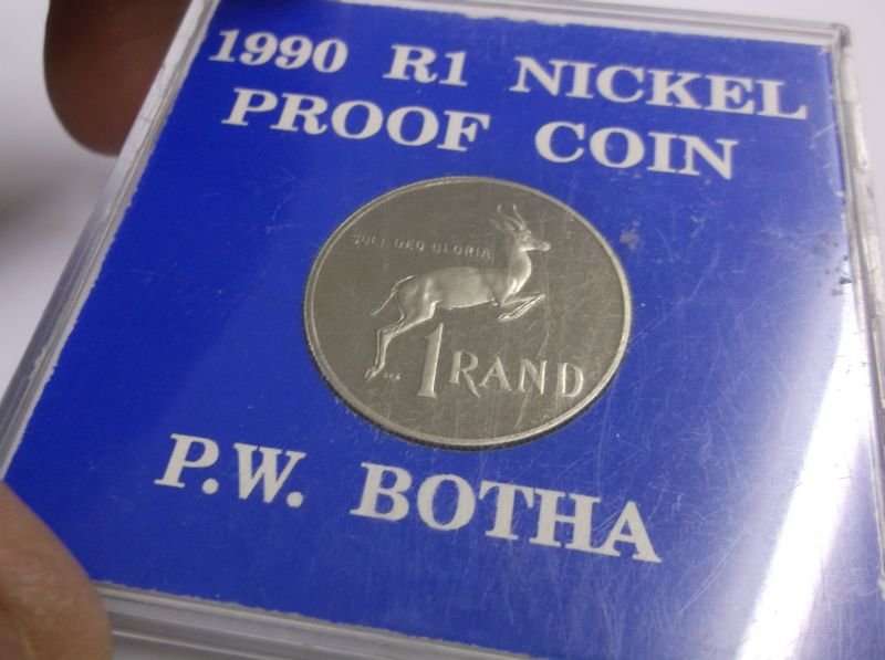 A PROOF 1990 ONE RAND COIN IN ITS PLASTIC HOLDER - P.W BOTHA