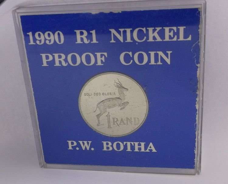 A PROOF 1990 ONE RAND COIN IN ITS PLASTIC HOLDER - P.W BOTHA
