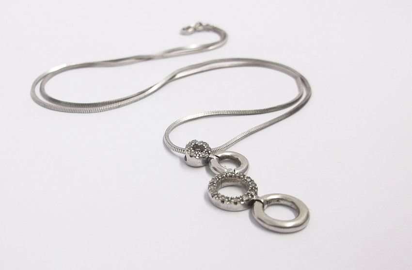 A VERY CLASSY SOLID 10 CT WHITE GOLD PENDANT SET WITH 18 TINY DIAMONDS PLUS STERLING SILVER NECKLACE
