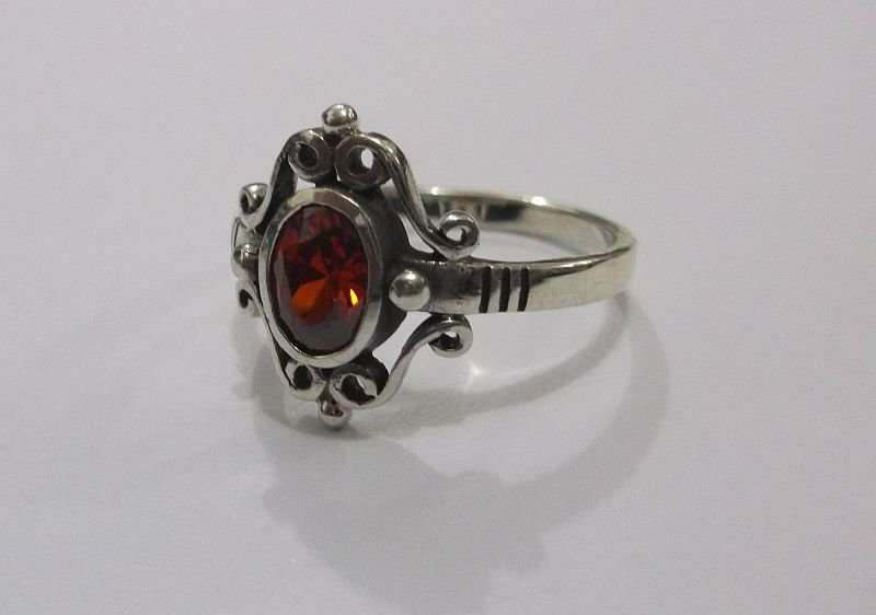 AN AWESOME SOLID STERLING SILVER RING WITH A STRIKING FACETED RED STONE ...MUST HAVE !!!