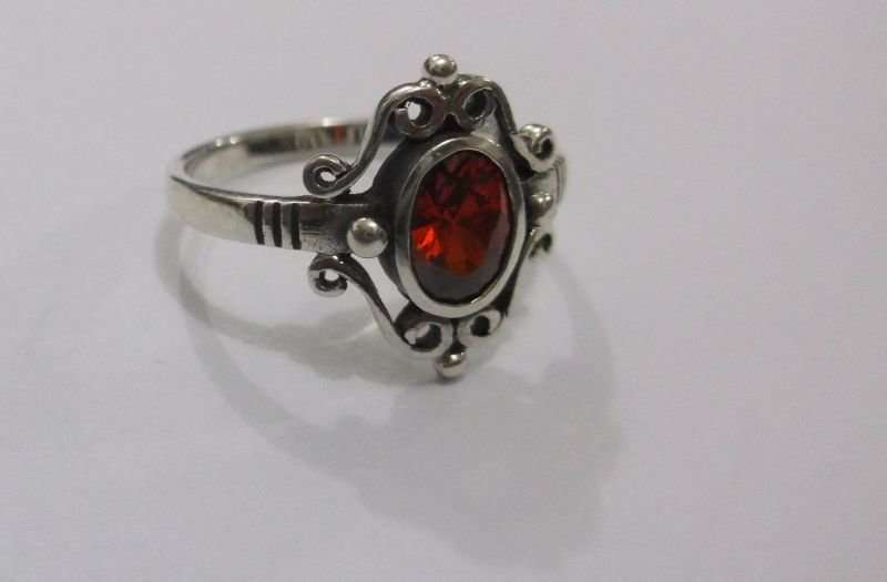 AN AWESOME SOLID STERLING SILVER RING WITH A STRIKING FACETED RED STONE ...MUST HAVE !!!