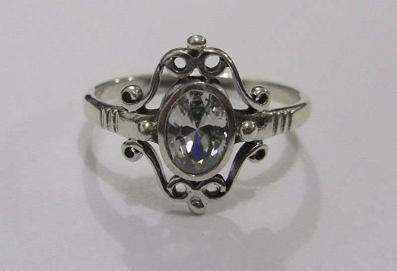 A SUPERB SOLID STERLING SILVER RING WITH FANCY DESIGN AND FACETED CLEAR STONE