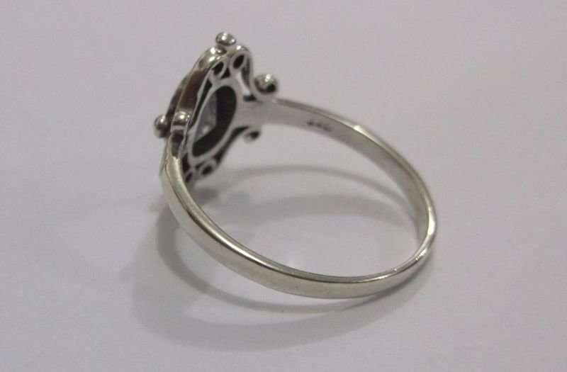 A SUPERB SOLID STERLING SILVER RING WITH FANCY DESIGN AND FACETED CLEAR STONE