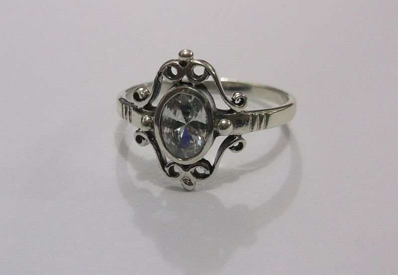A SUPERB SOLID STERLING SILVER RING WITH FANCY DESIGN AND FACETED CLEAR STONE