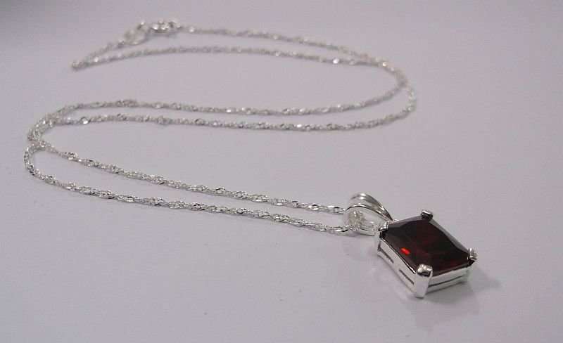 AWESOME STERLING SILVER PENDANT WITH A FIERY RED FACETED STONE PLUS A 45 CM STERLING SILVER NECKLACE