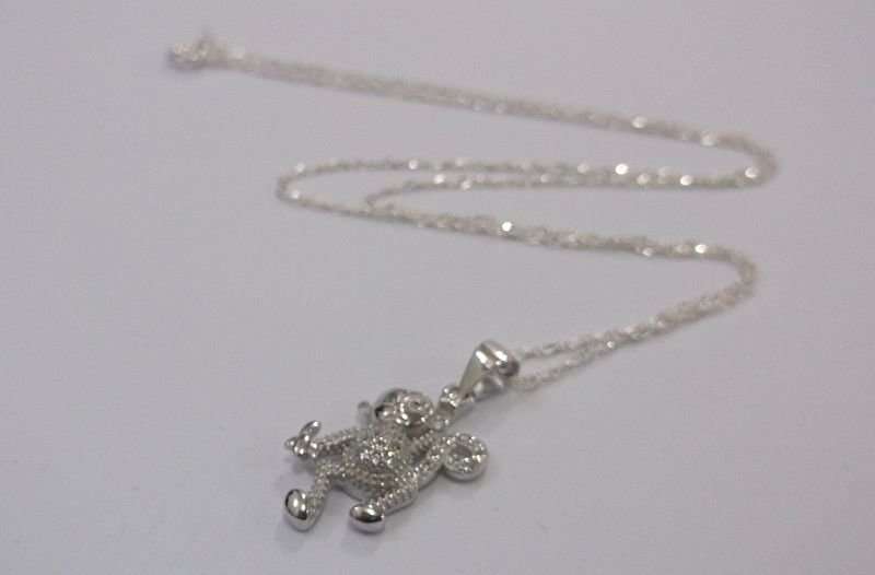 A CUTE STERLING SILVER MONKEY WITH BANANA PENDANT PLUS A 45 CM STERLING SILVER NECKLACE