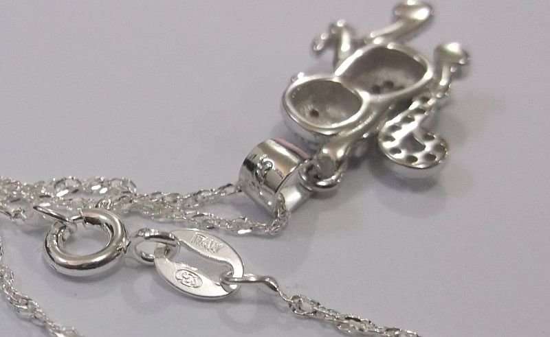 A CUTE STERLING SILVER MONKEY WITH BANANA PENDANT PLUS A 45 CM STERLING SILVER NECKLACE