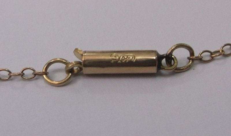 A STUNNING ANTIQUE 9 CARAT GOLD NECKLACE WITH TEAR SHAPED PENDANT AND FACETED RAINBOW LOOK STONE