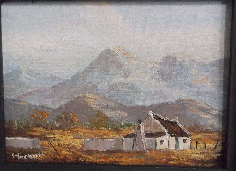 A LOVELY ORIGINAL OIL ON BOARD BY JUNE TUCKETT DEPICTING A HOMESTEAD SURROUNDED BY A MOUNTAIN RANGE