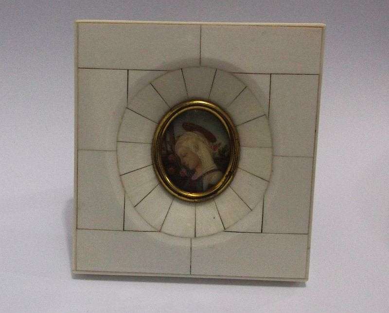 AN EXQUISITE OLD HAND PAINTED PICTURE OF A MAIDEN IN A PRE BAN IVORY OR BONE FRAME