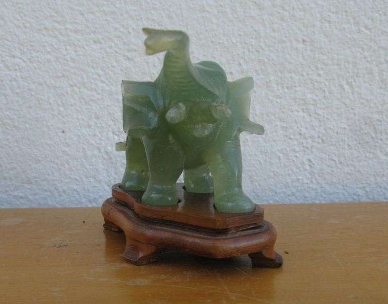 A BEAUTIFULLY CARVED JADE ELEPHANT ON A WOODEN PLINTH FROM THE 1930`S