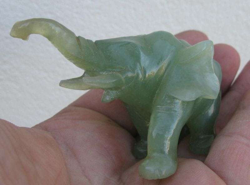 A BEAUTIFULLY CARVED JADE ELEPHANT ON A WOODEN PLINTH FROM THE 1930`S
