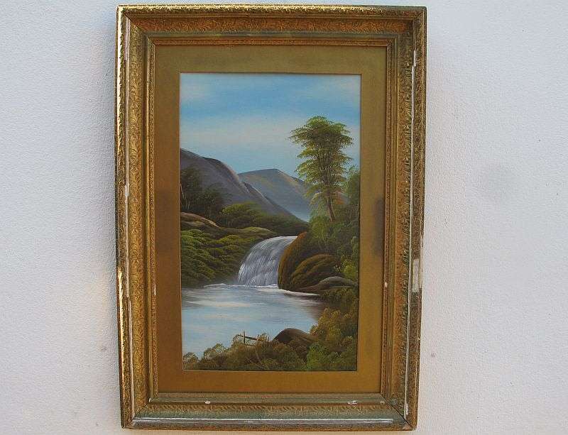 AN ANTIQUE ORIGINAL OIL ON BOARD OF A TRANQUIL WATERFALL AND FLOWING MOUNTAIN BACKGROUND