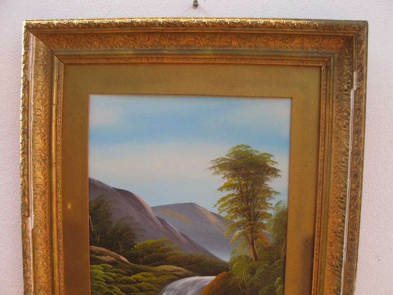 AN ANTIQUE ORIGINAL OIL ON BOARD OF A TRANQUIL WATERFALL AND FLOWING MOUNTAIN BACKGROUND