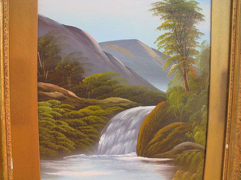 AN ANTIQUE ORIGINAL OIL ON BOARD OF A TRANQUIL WATERFALL AND FLOWING MOUNTAIN BACKGROUND