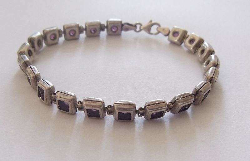 A GORGEOUS VINTAGE STERLING SILVER BRACELET SET WITH FACETED PURPLE STONES !! HINGED !! MUST HAVE !!