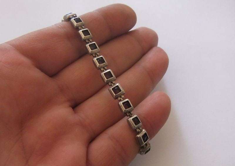 A GORGEOUS VINTAGE STERLING SILVER BRACELET SET WITH FACETED PURPLE STONES !! HINGED !! MUST HAVE !!