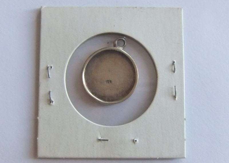 A SOLID STERLING SILVER ISLAMIC PENDANT