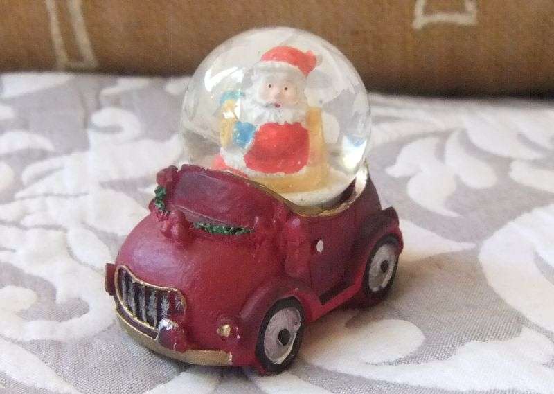 A SNOW GLOBE WITH SANTA FEATURE