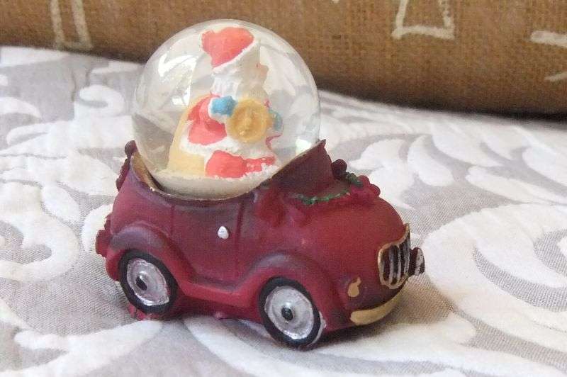 A SNOW GLOBE WITH SANTA FEATURE