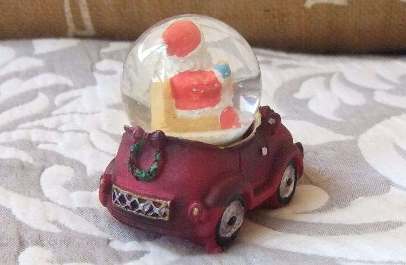 A SNOW GLOBE WITH SANTA FEATURE