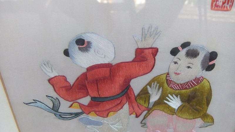 AN EYE CATCHING VINTAGE CHINESE EMBROIDERY...POSSIBLY SILK... FINE DETAIL WITH CHINESE CHARACTERS