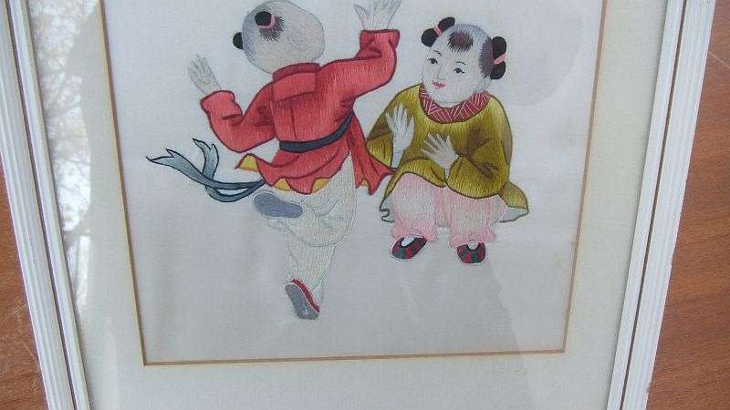 AN EYE CATCHING VINTAGE CHINESE EMBROIDERY...POSSIBLY SILK... FINE DETAIL WITH CHINESE CHARACTERS