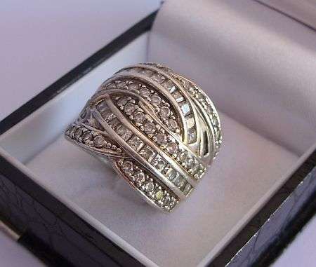 A VERY WELL MADE SOLID STERLING SILVER RING SET WITH A MASS AMOUNT OF FACETED CZ STONES