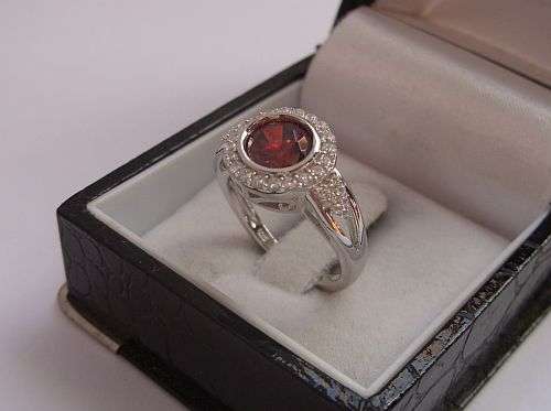 SHOCKING !!! A SUPERB STERLING SILVER RING SET WITH A FACETED RED STONE & CZ`S ....AWESOME !!!