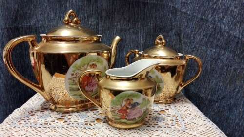 Unity teapot, sugar bowl, milk jug. Gilt with Victorian couple picture