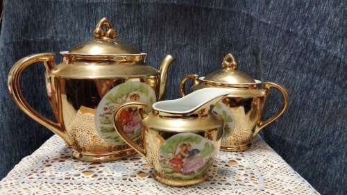 Unity teapot, sugar bowl, milk jug. Gilt with Victorian couple picture
