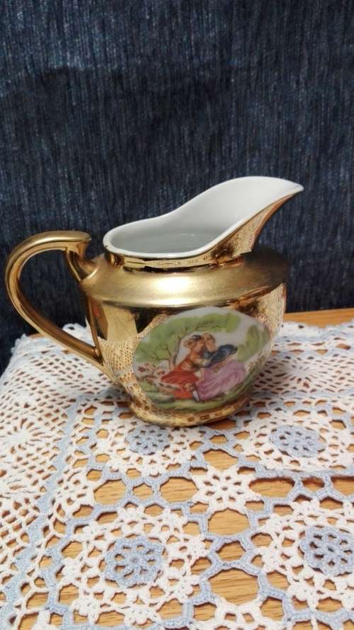 Unity teapot, sugar bowl, milk jug. Gilt with Victorian couple picture
