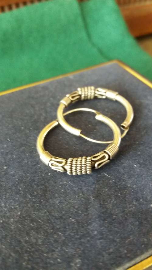 A Pair Of Silver Hoop Earrings