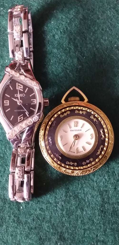 A Ladies Silver Tone Wrist Watch And A Gold Tone Pendant Watch - (Not Working)