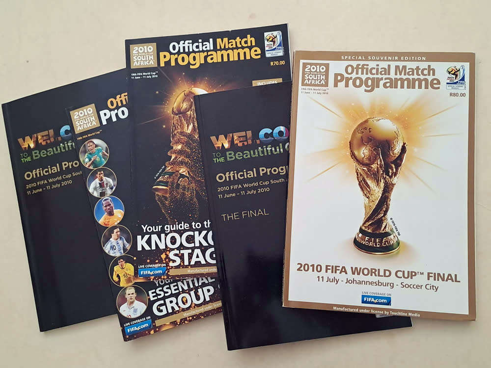FIFA World Cup Tournament brochures and 2010 Final Programmes with Zakumi mascot and pin badge