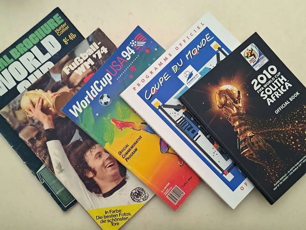 FIFA World Cup Tournament brochures and 2010 Final Programmes with Zakumi mascot and pin badge