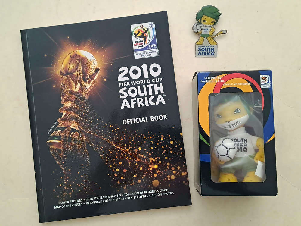 FIFA World Cup Tournament brochures and 2010 Final Programmes with Zakumi mascot and pin badge