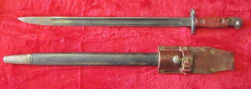 ## Military Issue 1907 Wilkinson Bayonet with Mangrovite Sheath and Leather Frog ##